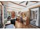 Open concept living room with tile flooring, ceiling fans and exposed wood beams at 31544 Wekiva River Trl, Sorrento, FL 32776