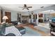 Comfortable living room with wood burning fireplace, hardwood floors, and archway to the kitchen at 31544 Wekiva River Trl, Sorrento, FL 32776