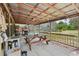 A covered patio with a picnic table, nice tile, and the pool view at 31544 Wekiva River Trl, Sorrento, FL 32776