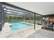Screened in pool with a full view of the fenced backyard and a partially covered pool deck with exercise equipment at 31544 Wekiva River Trl, Sorrento, FL 32776