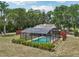 Backyard featuring a screened-in pool and wooden deck at 31544 Wekiva River Trl, Sorrento, FL 32776