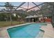 Beautiful backyard pool with an enclosed screen, landscaping, and view of the backyard at 31544 Wekiva River Trl, Sorrento, FL 32776