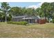 A view of the screened-in pool, landscaping, and the exterior of the house at 31544 Wekiva River Trl, Sorrento, FL 32776
