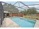 Beautiful backyard pool with an enclosed screen, view of the backyard, landscaping, and a privacy fence at 31544 Wekiva River Trl, Sorrento, FL 32776