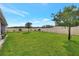 Large backyard with ample green space, enclosed by a white fence at 316 Nowell Loop, Deland, FL 32724