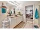 Bathroom with double vanity, granite countertop, walk-in shower, and access to a walk-in closet at 316 Nowell Loop, Deland, FL 32724