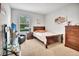 Comfortable bedroom featuring a TV, chair, and dresser with a warm and inviting atmosphere at 316 Nowell Loop, Deland, FL 32724