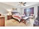 Comfortable bedroom featuring a ceiling fan, large bed, stylish furnishings, and ample natural light at 316 Nowell Loop, Deland, FL 32724