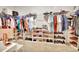 Walk-in closet features organized shelves for shoes, rods for hanging, and upper storage at 316 Nowell Loop, Deland, FL 32724