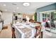 Bright dining room featuring a large table, chairs, and access to a screened patio with stylish decor at 316 Nowell Loop, Deland, FL 32724