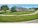 Well-maintained property featuring lush greenery and a concrete sidewalk at 316 Nowell Loop, Deland, FL 32724