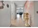 Hallway featuring tile flooring, arched doorway, decorative columns, and access to various rooms in the home at 316 Nowell Loop, Deland, FL 32724