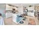 Modern kitchen with white cabinets, granite countertops, stainless steel appliances, and a center island with bar stools at 316 Nowell Loop, Deland, FL 32724