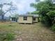 Back exterior of a single-story home with trees and grass at 317 Inwood Ave, New Smyrna Beach, FL 32168