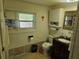 Bathroom boasts an ornate vanity, a decorative mirror, and a tropical-themed window accent at 317 Inwood Ave, New Smyrna Beach, FL 32168