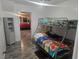 Comfortable bedroom with bunk beds, closet, and a view to the primary bedroom at 317 Inwood Ave, New Smyrna Beach, FL 32168