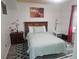 Comfortable bedroom with wood-look floors, patterned rugs, and light blue bedding at 317 Inwood Ave, New Smyrna Beach, FL 32168
