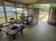 Enclosed sunroom with dining set and view of yard at 317 Inwood Ave, New Smyrna Beach, FL 32168