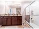 Bathroom with double vanity, granite countertops, and a glass-enclosed shower at 343 Lazio Cir, Debary, FL 32713