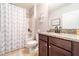 A bathroom features a vanity with granite countertops, updated fixtures, and a shower and tub combination at 343 Lazio Cir, Debary, FL 32713