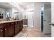 Well-lit bathroom with a double vanity, granite countertops, and a glass-enclosed shower at 343 Lazio Cir, Debary, FL 32713