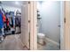 A view of the bathroom with an adjacent walk-in closet shows a toilet and floating shelves at 343 Lazio Cir, Debary, FL 32713