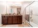 Bathroom features dual sinks, granite countertop, tile floor, and a glass shower at 343 Lazio Cir, Debary, FL 32713