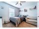Cozy bedroom with ceiling fan, decorative shelves, and a comfortable seating area at 343 Lazio Cir, Debary, FL 32713