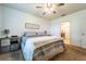 Relaxing bedroom with a ceiling fan, soft carpet and a view of the bathroom at 343 Lazio Cir, Debary, FL 32713