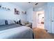 Bright bedroom with ceiling fan and doorway leading to hallway with tile flooring at 343 Lazio Cir, Debary, FL 32713