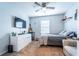 Comfortable bedroom features a ceiling fan, dresser, TV, and neutral decor at 343 Lazio Cir, Debary, FL 32713