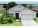 Charming single-Gathering home featuring a two-car garage, well-maintained landscaping, and a cozy front entrance at 343 Lazio Cir, Debary, FL 32713