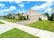 This attractive home features a brick driveway, a lush lawn, and mature landscaping, with a two-car garage at 343 Lazio Cir, Debary, FL 32713