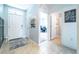 Bright foyer with tile flooring featuring front door, side door, and an entrance to a room at 343 Lazio Cir, Debary, FL 32713