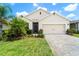 Charming front exterior with a brick driveway, a lush lawn, and mature trees, providing ample curb appeal at 343 Lazio Cir, Debary, FL 32713