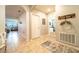 Hallway with neutral tile, wall decorations, and access to other rooms in the house at 343 Lazio Cir, Debary, FL 32713