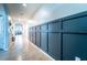 Inviting hallway with decorative wall panels and tile flooring that leads to other rooms in the home at 343 Lazio Cir, Debary, FL 32713