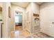 Hallway with neutral tile, wall decorations, laundry room, and access to other rooms at 343 Lazio Cir, Debary, FL 32713