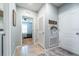 Hallway with tile flooring leading to bedroom with ceiling fan and natural light at 343 Lazio Cir, Debary, FL 32713
