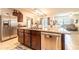 Open kitchen with granite countertops, stainless appliances, and seamless flow to dining and living areas at 343 Lazio Cir, Debary, FL 32713