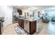 Stylish kitchen with stainless steel appliances, granite countertops, kitchen island, and open view to the living room at 343 Lazio Cir, Debary, FL 32713
