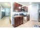 Well-equipped kitchen with stainless steel appliances, dark wood cabinetry, and light granite countertops at 343 Lazio Cir, Debary, FL 32713