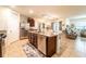 Open concept kitchen featuring stainless appliances, granite island, and view of living area at 343 Lazio Cir, Debary, FL 32713