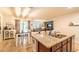 Open kitchen featuring an island with granite countertops, stainless steel sink, and dark wood cabinetry at 343 Lazio Cir, Debary, FL 32713