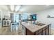Open-concept kitchen with granite countertops, a kitchen island, dining area, and a view of the living room at 343 Lazio Cir, Debary, FL 32713