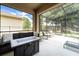 Spacious screened-in lanai featuring a fire pit, comfortable seating, and outdoor living space at 343 Lazio Cir, Debary, FL 32713