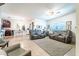 Open-concept living room with tile floors and comfortable seating, leading to the kitchen and dining area at 343 Lazio Cir, Debary, FL 32713