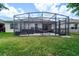 View of screened patio featuring ample seating with outdoor grill and hammock for leisure at 343 Lazio Cir, Debary, FL 32713