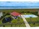 Aerial view of community playground with splash pad, picnic pavilion, and fenced-in play area at 343 Lazio Cir, Debary, FL 32713
