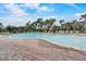 Large community pool surrounded by lush landscaping and plenty of lounge chairs at 343 Lazio Cir, Debary, FL 32713